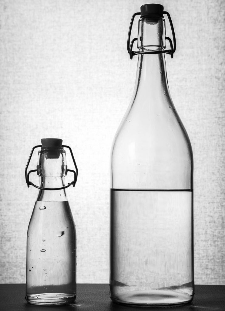 1 small and 1 large glass bottle with natural mineral water